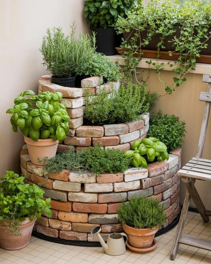 Tiered brick planters filled with lush green basil and rosemary herbs on a terrace.